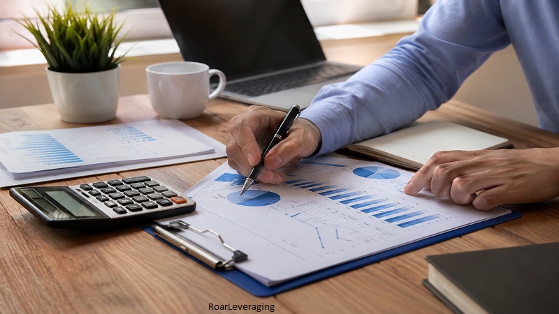 Professional analyzing financial reports and charts to demonstrate RoarLeveraging for smarter financial planning and business growth.