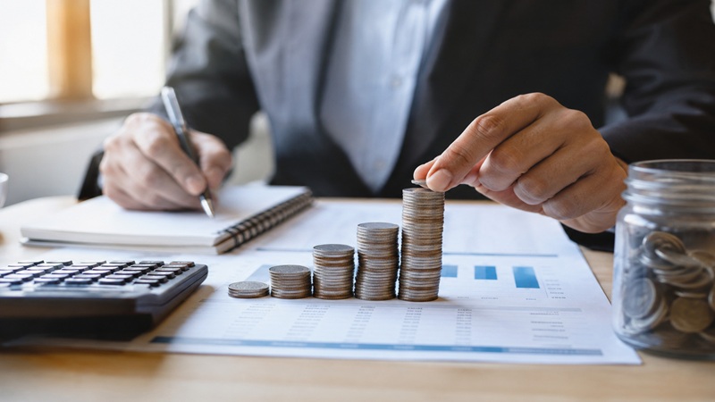 Financial tricks roarleveraging concept showing a professional managing savings, coins, and financial planning.